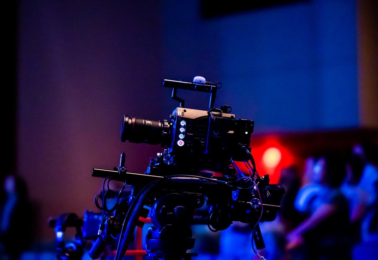 A high-quality camera setup capturing a live studio event with an audience in the background.